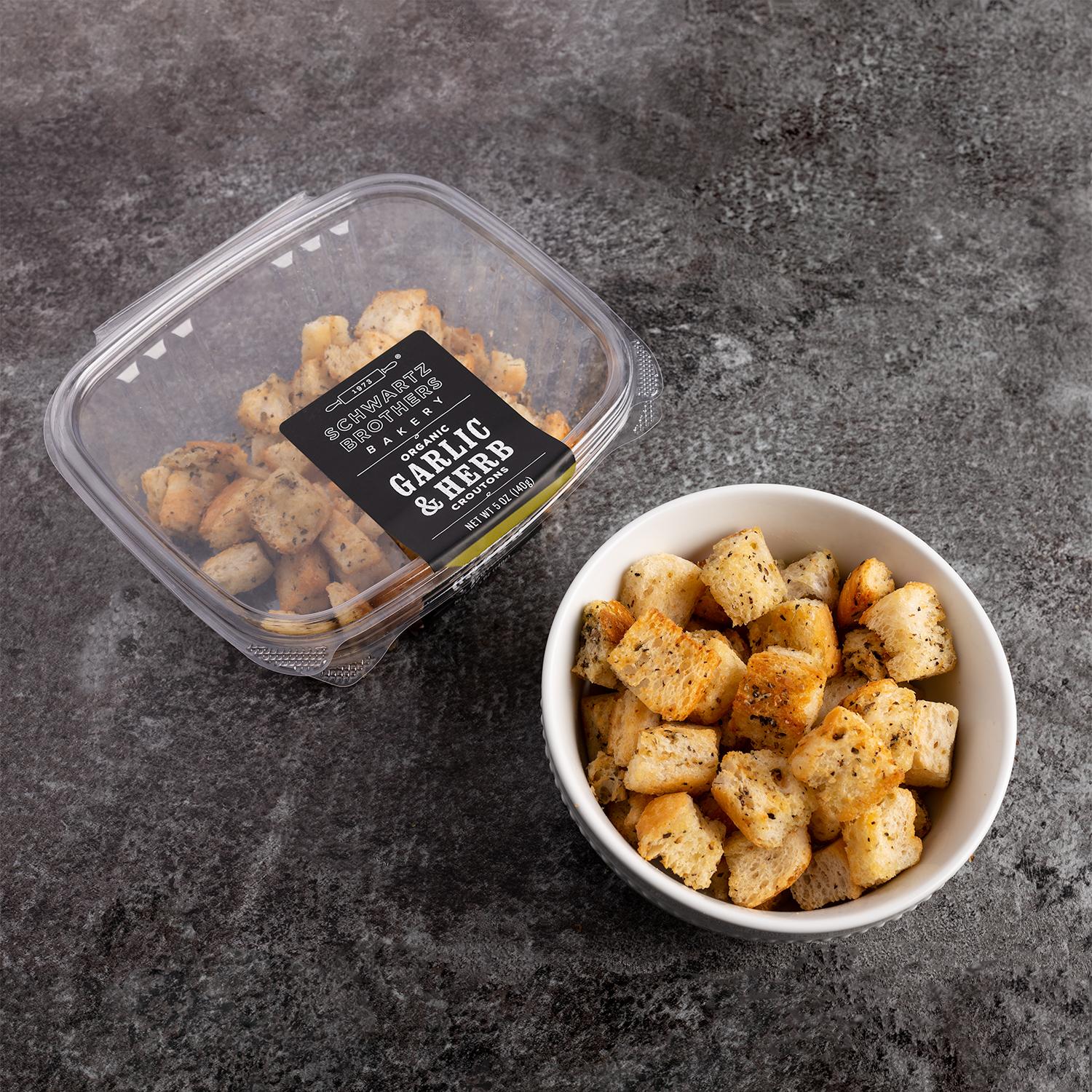 Garlic and Herb Croutons in a bowl next to a half-empty package