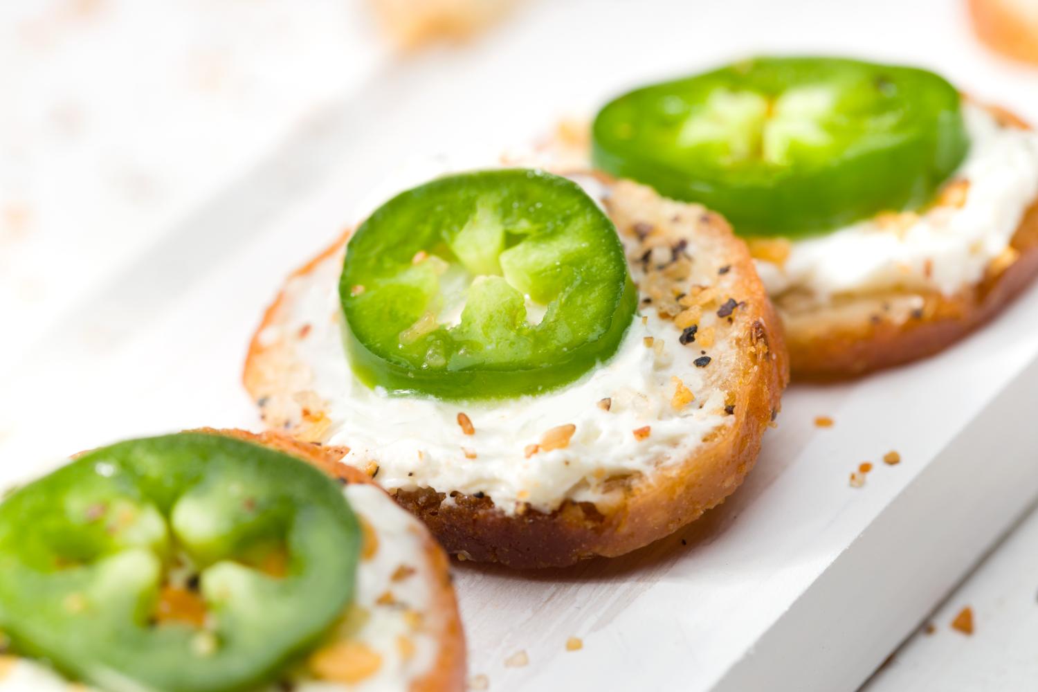 Everything Bagel Chips topped with sour cream and a jalapeño